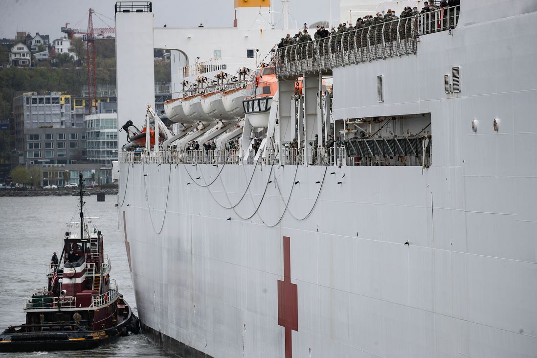 Naval Hospital Ship Comfort personnel line the decks as they depart via the Hudson River, in Manhattan